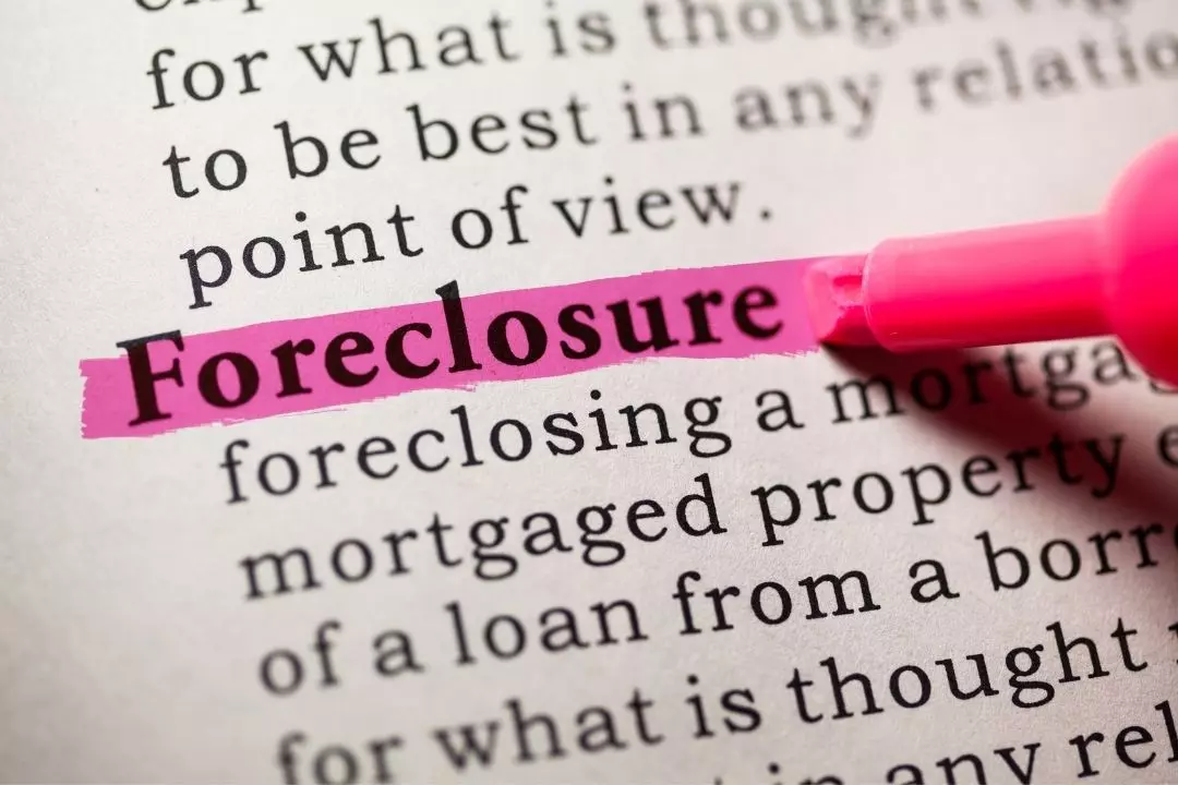 Foreclosure bailout loan for a Tampa home, showcasing a real estate sign and house exterior.