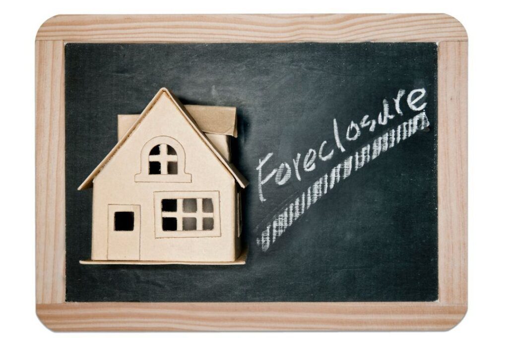 Chalkboard illustration showing a house, symbolizing mortgage default causes.