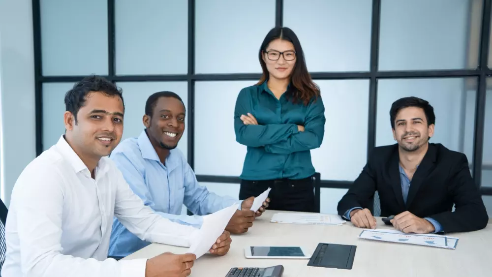 Professional business meeting at a modern office with individuals discussing strategies.