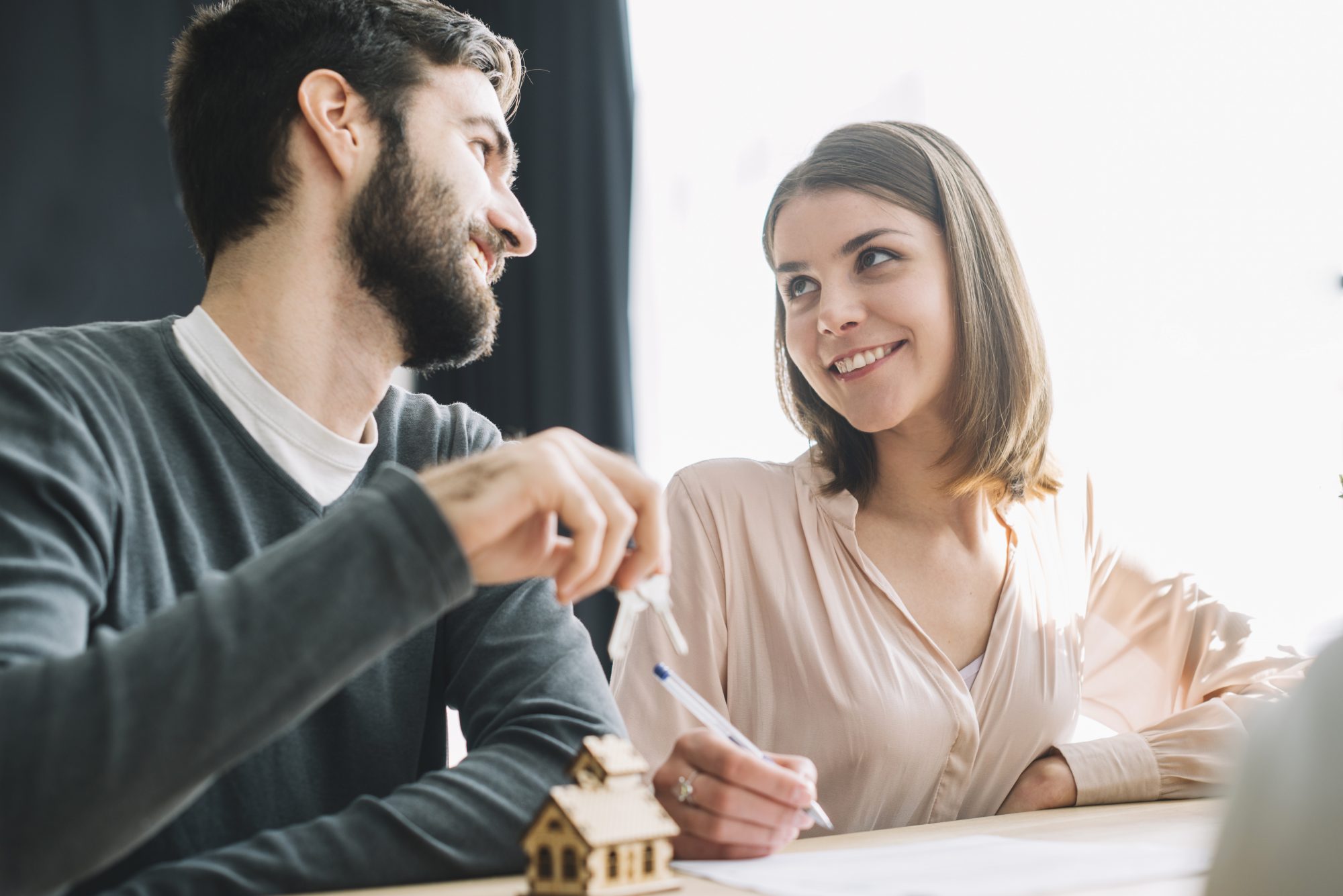 A couple meeting with a real estate agent to discuss property options.