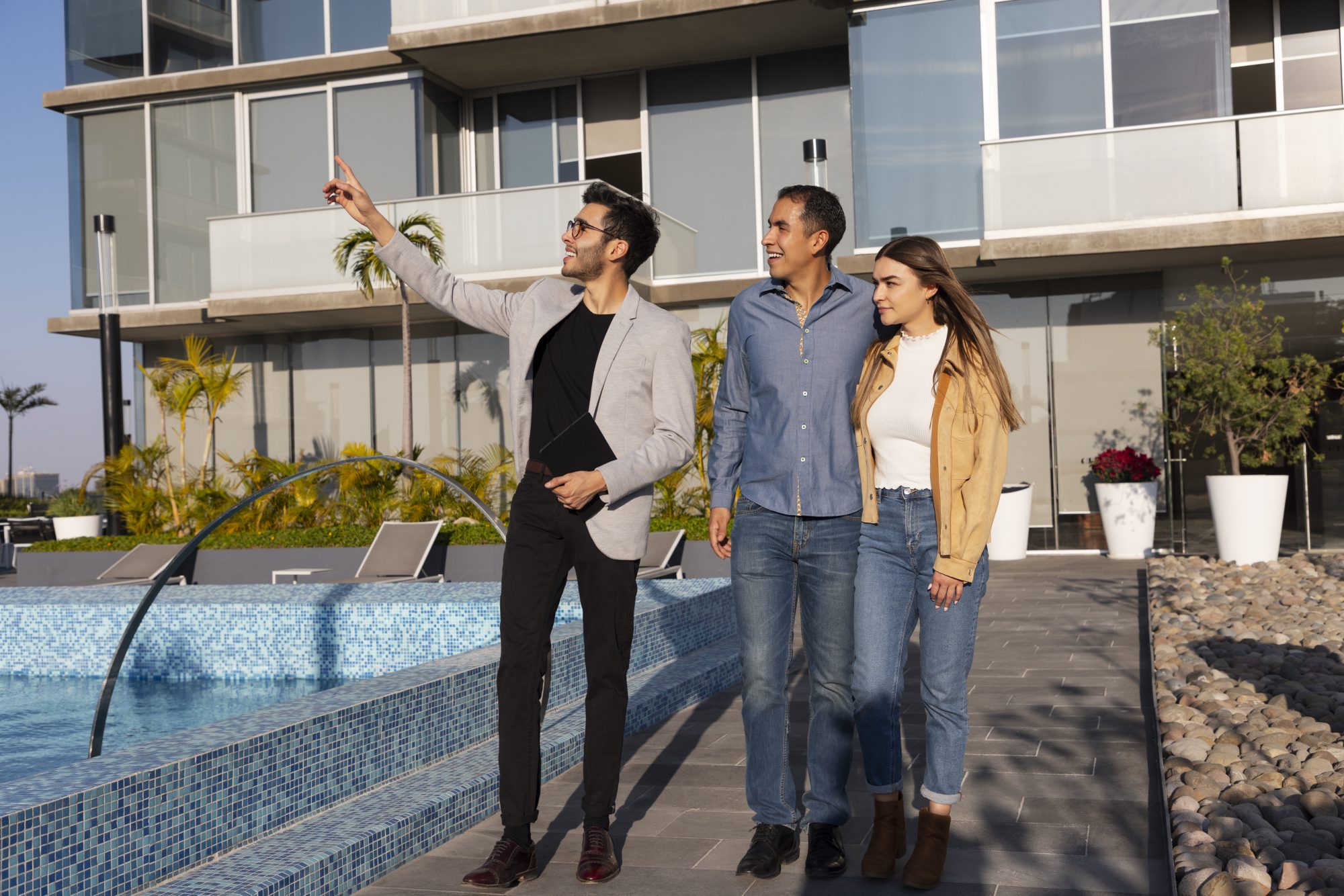 A couple discussing with a real estate agent in a professional setting