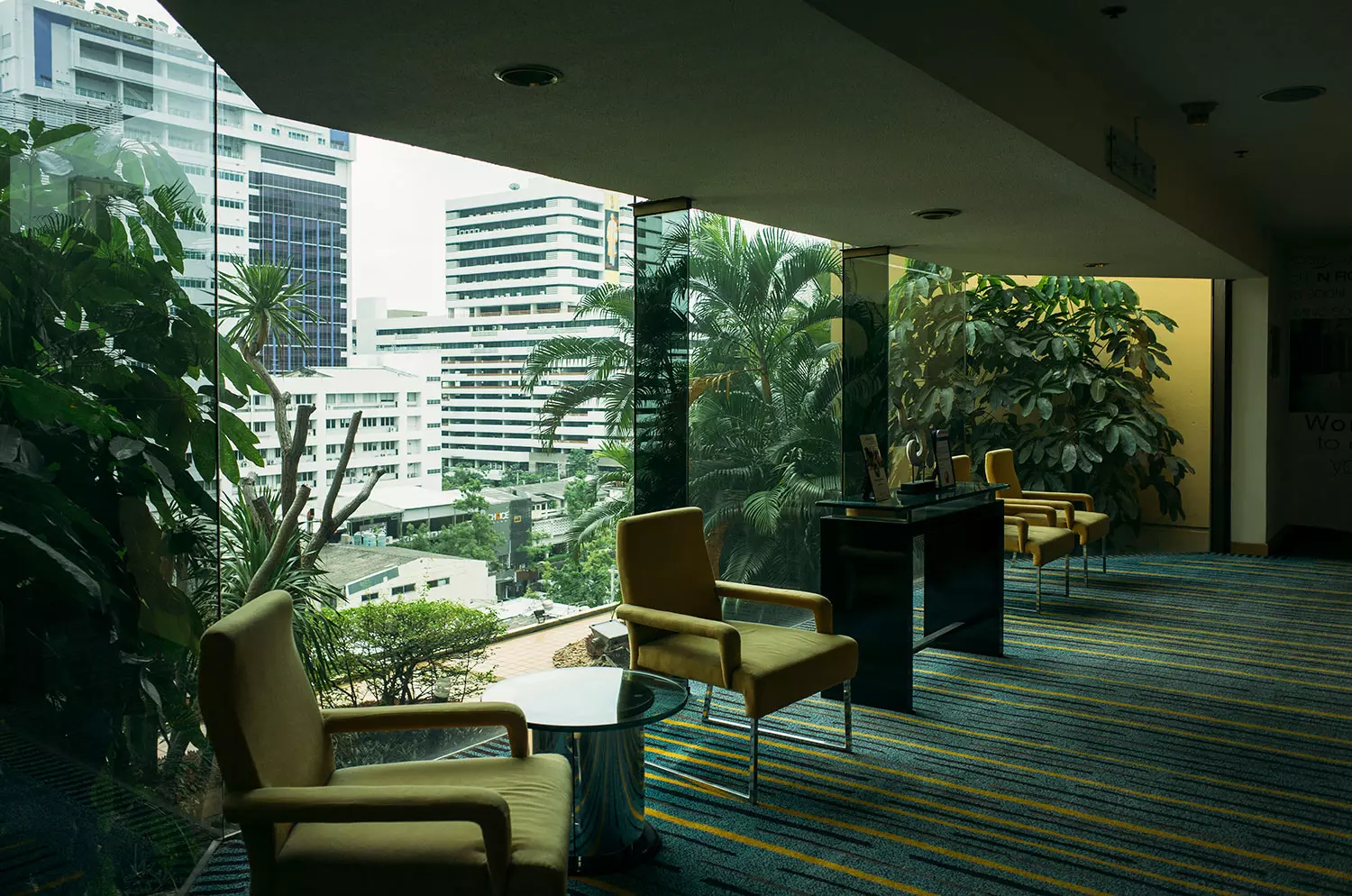 A sleek, modern office workspace featuring a large desk, computer, and ergonomic chair in a bright setting.